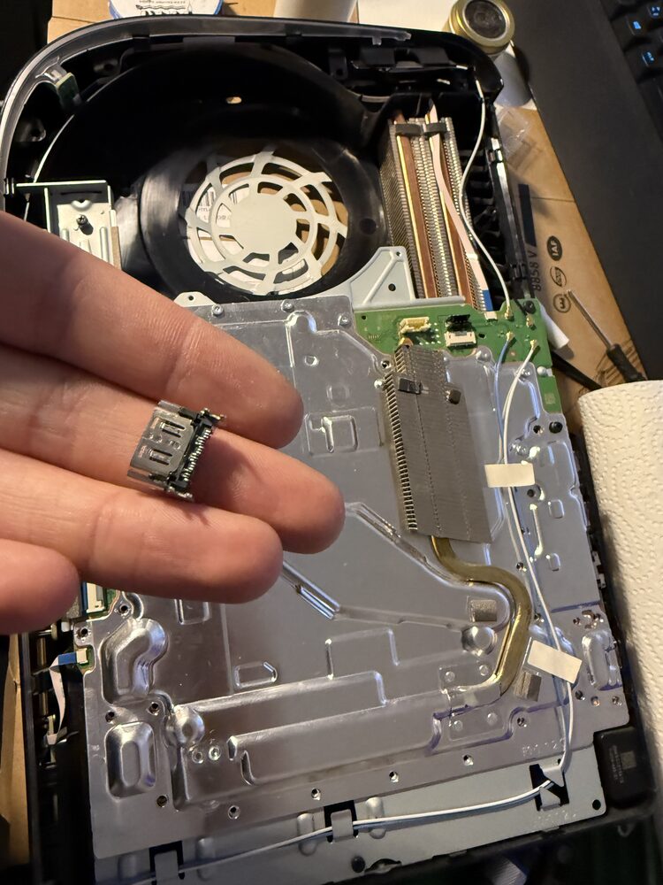 Ausgebauter HDMI-Port einer PlayStation 5 in der Hand